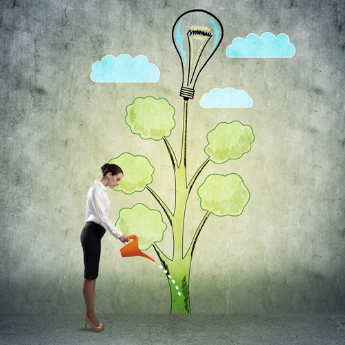 woman watering a drawing of a tree with a light bulb growing from the top